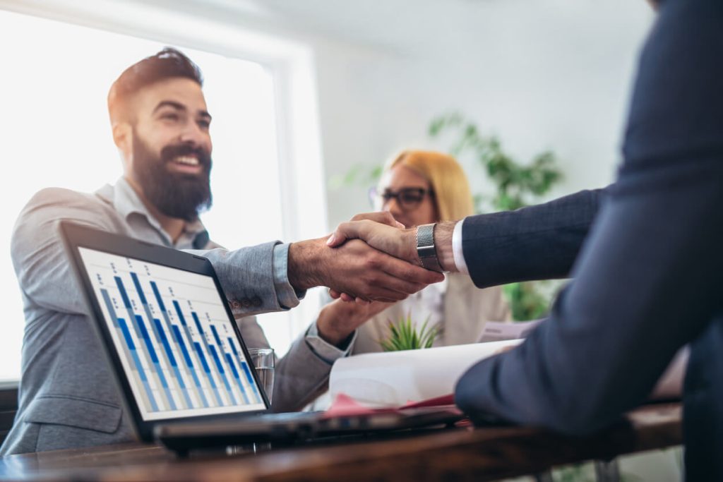 Young business people shaking hands in an office